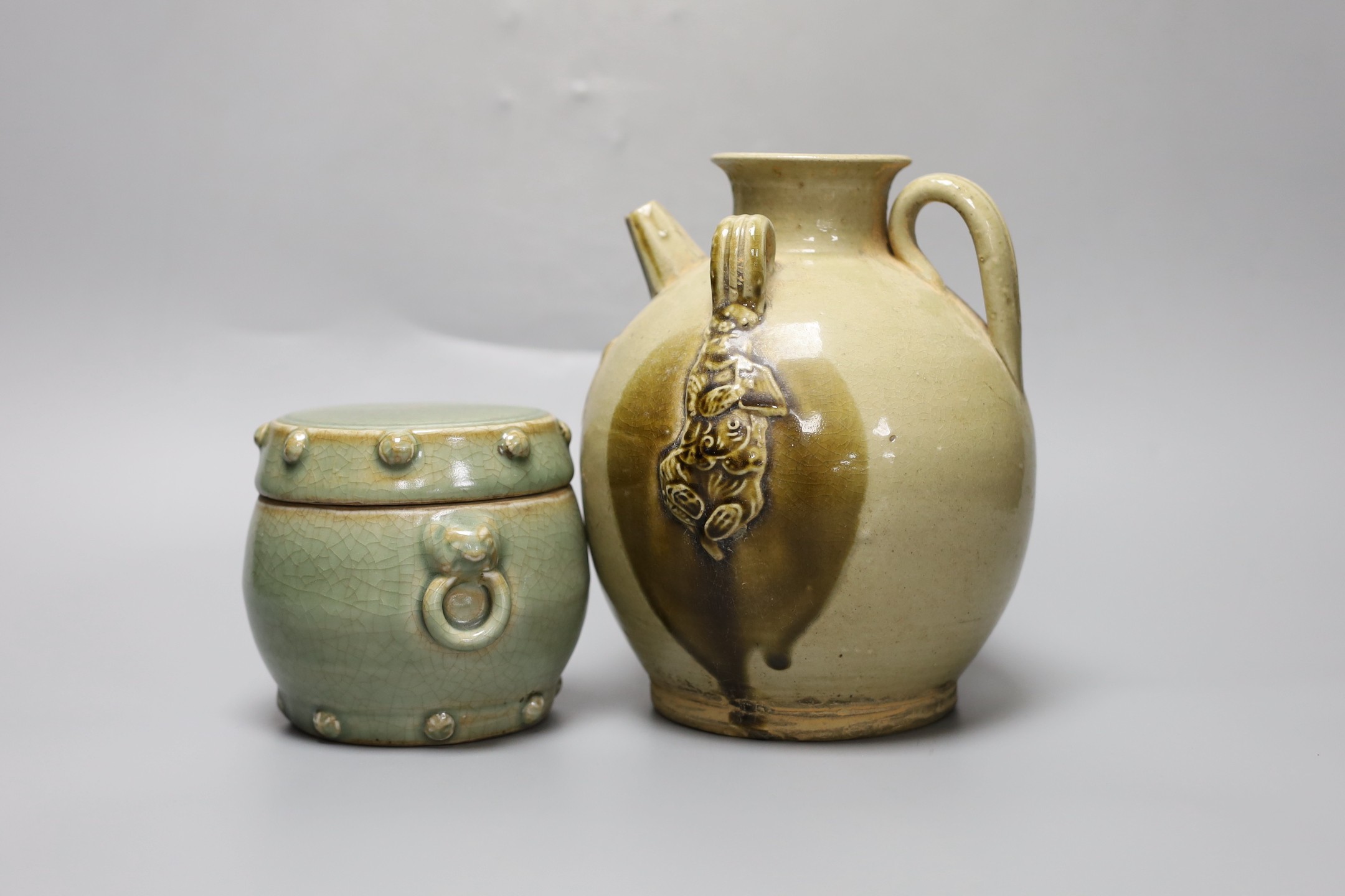 A Chinese buff-glazed wine pot and celadon jar and cover, 18.5cm